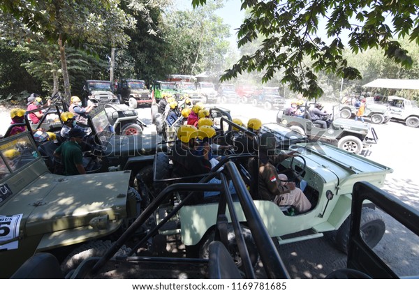 Yogyakarta, Indonesia - August 25, 2018: Groups\
of tourists ride willys jeep to explore the tourist spots of Merapi\
volcanic eruptions in Cangkringan village, Sleman, Yogyakarta,\
Indonesia