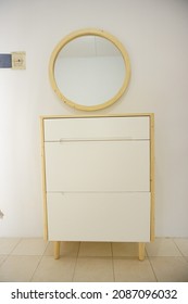 Yogyakarta, Indonesia - December  7 2021: Minimalist wooden shoe cabinet with mirror taken from several different angle.