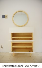 Yogyakarta, Indonesia - December  7 2021: Minimalist wooden shoe cabinet with mirror taken from several different angle.