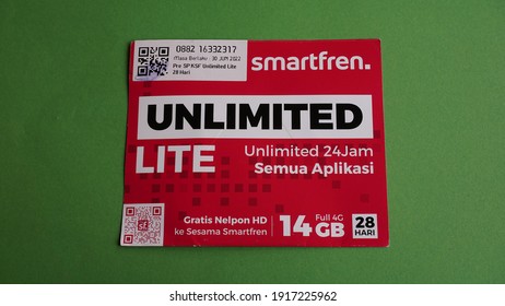 Yogyakarta, Indonesia - Feb 15th 2021 Prepaid Sim Card Package  Of Smartfren Unlimited Preloaded Internet Data Credit, From Smartfren Telecom Indonesia Cellular Operator Provider On Green Background