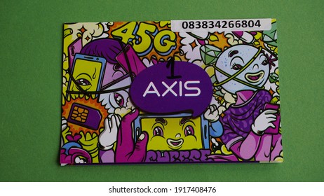 Yogyakarta, Indonesia Feb 15th 2021 Prepaid Axis Internet Package Sim Card From XL Axiata Indonesia Company Member Of Big Asian Cellular Provider Group Isolated On Green Background