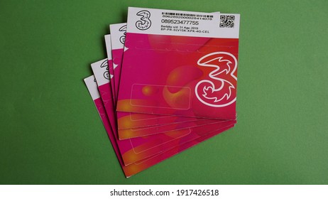 Yogyakarta, Indonesia Feb 15th 2021 Pile or stack view of prepaid Three or Tri regular package sim card from Hutchison 3 Indonesia company isolated on green background