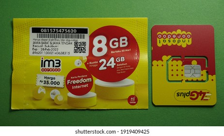 Yogyakarta, Indonesia Feb 17th 2021 Prepaid 8 GB Internet Package From Indosat Ooredoo Cellular Provider Operator From Qatar Telecom And Sample Sim Card Chip On The Right, Isolated On Green Background