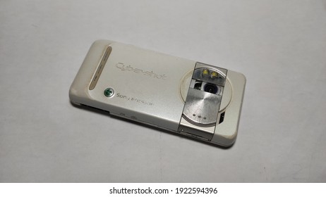 yogyakarta, indonesia - february, 23, 2021 - Photo of back of Sony Ericsson mobile phone with camera cover open on white colored paper with the help of additional light. selective focus