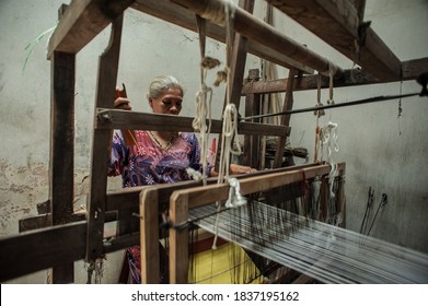 Yogyakarta, Indonesia: January 5, 2017: A mother who is the only traditional weaving cloth maker in Yogyakarta