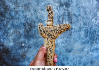 
YOGYAKARTA, INDONESIA - JULY 2, 2019 : Close up ancient kris (keris) with abstract background.