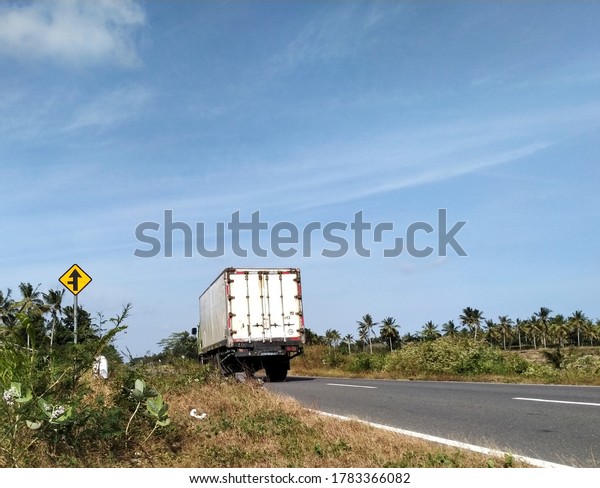 Yogyakarta, Indonesia, July 25th 2020. Box\
truck across the street, truk membawa muatan box , lewat di jalan\
di siang hari di kawasan JLSS Jawa\
Tengah