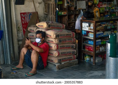 Yogyakarta, Indonesia - July 8 2021, Potrait Of Building Equipment Shop Keeper, He Using Mask While Work, During Coronavirus Pandemic