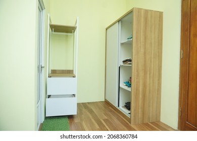 Yogyakarta, Indonesia - November 3 2021: Wooden wardrobe with sliding door and open wardrobe in a room taken from several angle.