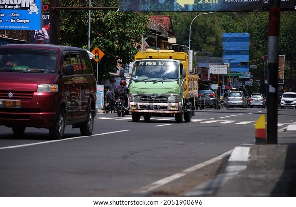 Yogyakarta, Indonesia - October 04, 2021: a\
truck full of loads is passing on the\
highway