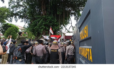 Yogyakarta, Indonesia – October 8 2020: POV From Behind A Heavily Armed Police Barricade Who Stood Confining Protesters At A Demonstration Against The Job Creation Law In Front Of The DPRD