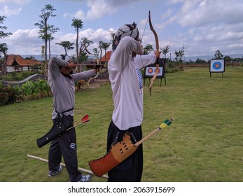 Yogyakarta, Indonesia - Sept 26, 2021: traditional archer aiming, archery is a sport with a bow and arrow made of bamboo and fiber