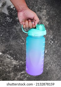 Yogyakarta - January 03 2022: A Hand Hold Big Colorful Sport Drinking Bottle That Can Contain 2 Litre Suitable For Hiking Or Diet