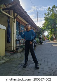 Yogyakarta, July 16, 2021 A Child Is Playing Badminton In Front Of The House