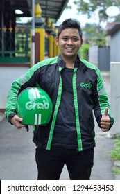 Yogyakarya, 23 January 2019 : A Grab Driver Is Ready With His Full Attributes, Namely Jackets And Helmets.