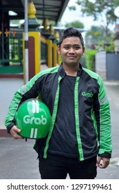 Yogyakarya, 23 January 2019 : A Grab Driver Is Ready With His Full Attributes, Namely Jackets And Helmets.