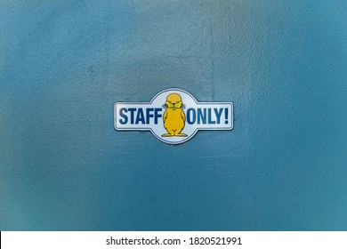 Yokohama, Japan - July 19 2020: A Staff Only Caution Mark With An Illustration Of An Earless Seal Or A Steller Sea Lion On A Blue Wall Of The Amusement Park Of Yokohama Hakkeijima Sea Paradise.