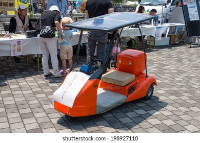 YOKOHAMA, JAPAN - May 31, 2014: A Solar Car Is Displayed In Front Of The Booth Of An NPO Called 