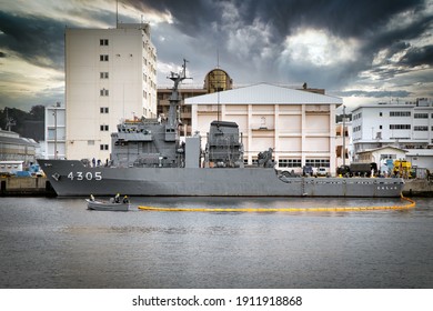 Yokosuka, Kanagawa  Japan – October 28, 2020: Japan Maritime Self Defense Force Sailors Place A Preventive Floating Barrier Around A Ship In The Harbor.