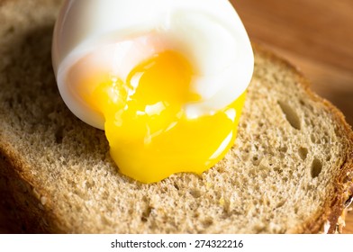 The Yolk Flows From Boiled Egg On Toast