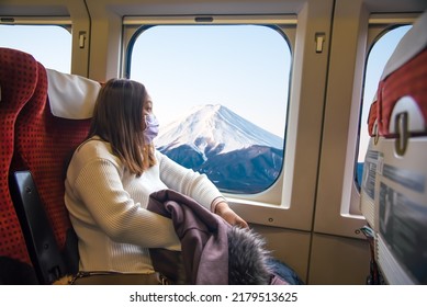 Yong Asian Woman Sitting In The High-speed Train While Traveling In Japan.