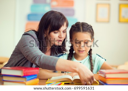 Yong Beautiful Teacher With Schoolgirl School At Classroom Yong Beautiful Teacher With Schoolgirl School At Classroom