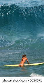 Yong girl ready for surfing on Ipanema Beach in Rio De Janeiro, Brazil