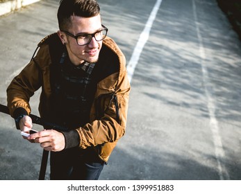 Yong Man On The Kickscooter Holding Phone