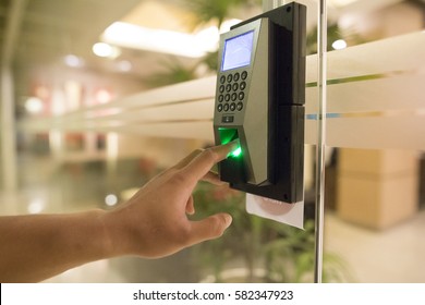 Yong man push down the electronic control machine to access the door - Shutterstock ID 582347923