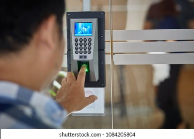 Yong man push finger down on the electronic control machine to access the door 
