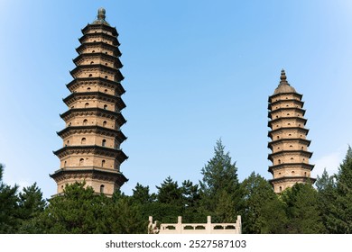 Yongzuo Temple, also known as the Twin Pagodas Temple, Taiyuan, Shanxi, China, Asia, with blue sky, white clouds and sunlight illuminating the tall towers - Powered by Shutterstock