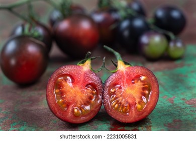 Yoom tomatoes on an old brown and green board, bird's eye view - Shutterstock ID 2231005831