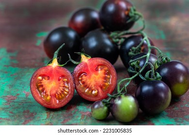 Yoom tomatoes on an old brown and green board, bird's eye view - Shutterstock ID 2231005835