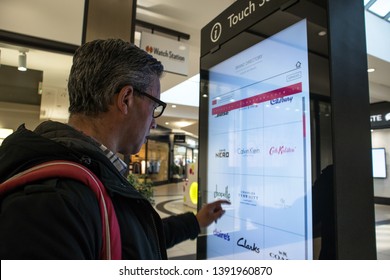 York / Great Britain - March 29, 2019 : Adult Man Using An Interactive Touch Display Information Board In A Shopping Mall Centre