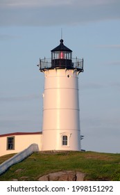 York, Maine, USA, July 16, 2019: Southern Maine's Iconic Nubble Lighthouse Glows As Day Begins To Transition Into Night.
