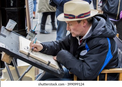 YORK, UK - 26 MARCH 2016.  Street Portrait Artist Drawing Caricature Of Customer 