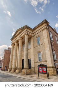 York, UK. August 3, 2021. Tall Columns At The Entrance To A Methodist Church.  Steps Lead Up To The Doors And A Notice Board Is In The Foreground.