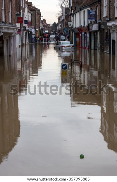 YORK, UK - DECEMBER 28th 2015: Flooded streets of\
York City Centre and a submerged car after heavy rain, on 28th\
December  2015,