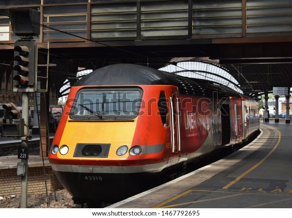 York UK July 30 2019 LNER High Speed Train\
(HST) Class 43 power car pauses to a halt in York Station en route\
for London. The locomotive was built by British Rail & has\
been in service since 1979