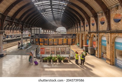 York, UK.  September 7, 2021.   A Station Concourse With An Electronic Notice Board. An Elaborate 19th Century Canopy Is Overhead And Railway Staff Stand To One Side.