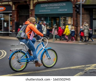 York, Yorkshire, UK, 03/03/2020 Woman On A Bicycle Riding Through A Road Junction