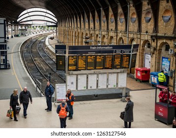 York, Yorkshire, UK.  January 30, 2018 At York Railway Station With Passengers And Railway Staff Around An Electronic Notice Board.