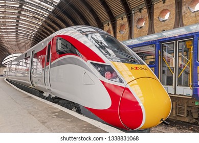 York, Yorkshire, UK. March 12, 2019. The new Azuma, bullet-shaped train of the LNER, beside a platform at York Station.  It’s clean lines contrast with the overhead, 19th Century architecture.