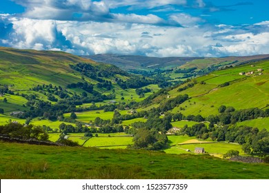 The Yorkshire Dales.  Askrigg road to Gunnerside in Swaledale.  Farmsteads, drystone walling, fields and meadows with the River Swale running through the Dale.  Horizontal.  Space for copy. - Shutterstock ID 1523577359