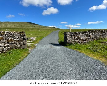 Yorkshire Dales moor top road, with, dry stone walls, distant hills, and a blue sky near, Halton Gill, Craven, UK - Shutterstock ID 2172198327