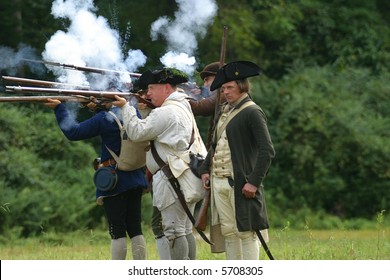 The Yorktown Virginia Militia Fire Their Muskets During A Battle Against The English While A Reenacting.