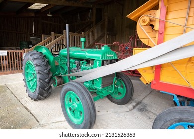 York.Yorkshire.United Kingdom.February 16th 2022.A Ransomes threshing machine connected to a green fordson tractor is on display at the Yorkshire museum of farming
