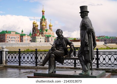 Yoshkar-Ola, Russia - September 6, 2021. Monument to A.S. Pushkin with his literary hero Eugene Onegin. Resurrection embankment. Opened in 2011. Against  backdrop of the Cathedral of the Annunciation