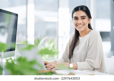 You accomplish a lot more with a positive mindset. Portrait of a young businesswoman working on a laptop in an office.