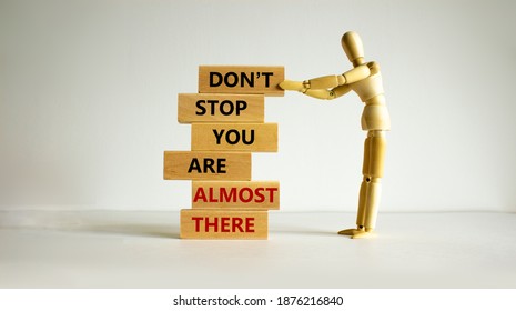 You are almost there symbol. Wooden blocks with words 'dont stop you are almost there'. Wooden model of human. Beautiful white background, copy space. Business and almost there concept. - Shutterstock ID 1876216840